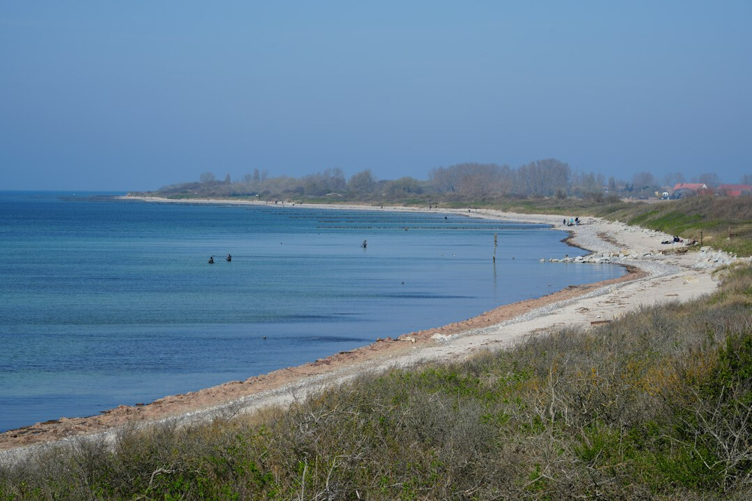 Narrow coastal peninsula with beaches on both sides and calm ocean waters